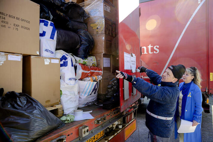  Een vrachtwagen wordt gereed gemaakt voor vertrek door Oekraïense en Poolse medewerkers van transportbedrijf Smeets Ferry